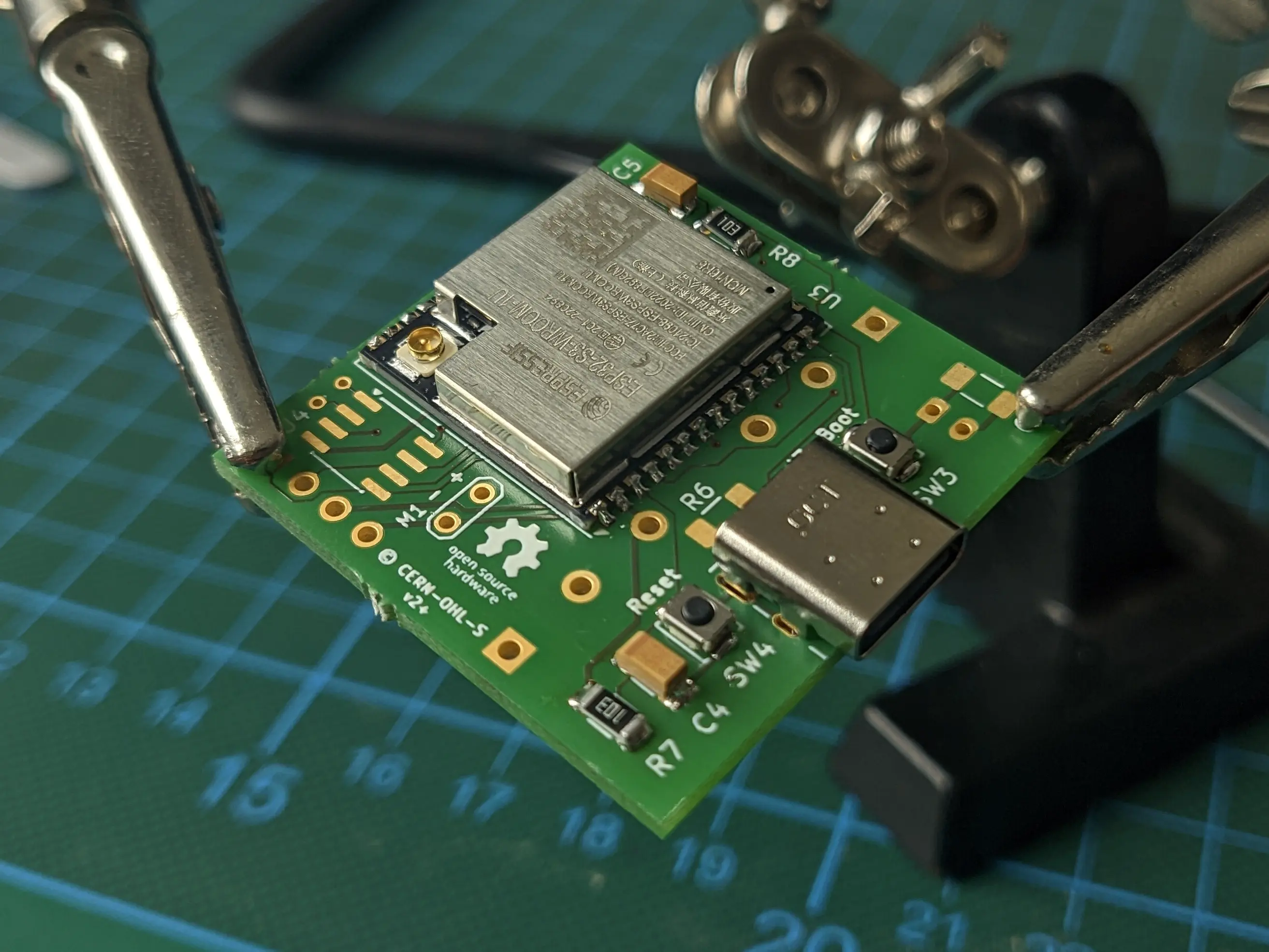 The same PCB from the same side at a slightly different angle, showing a USB-C port, two buttons and some other components being populated.