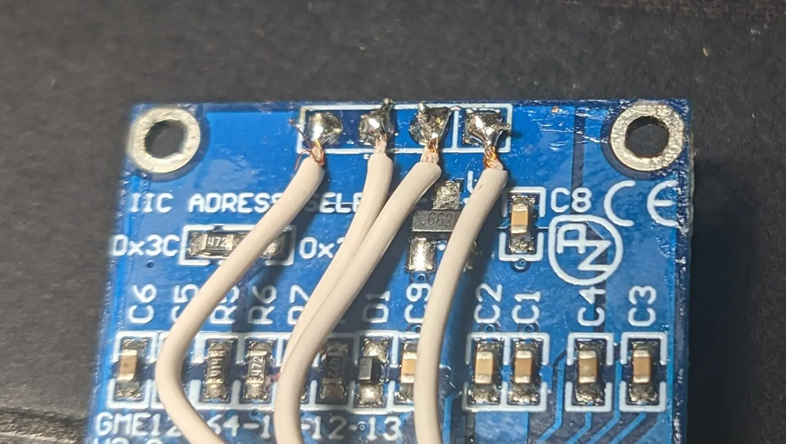 Closeup of the Display board back. The header pins have been cut off close to the PCB. Four wires have been connected to the pins