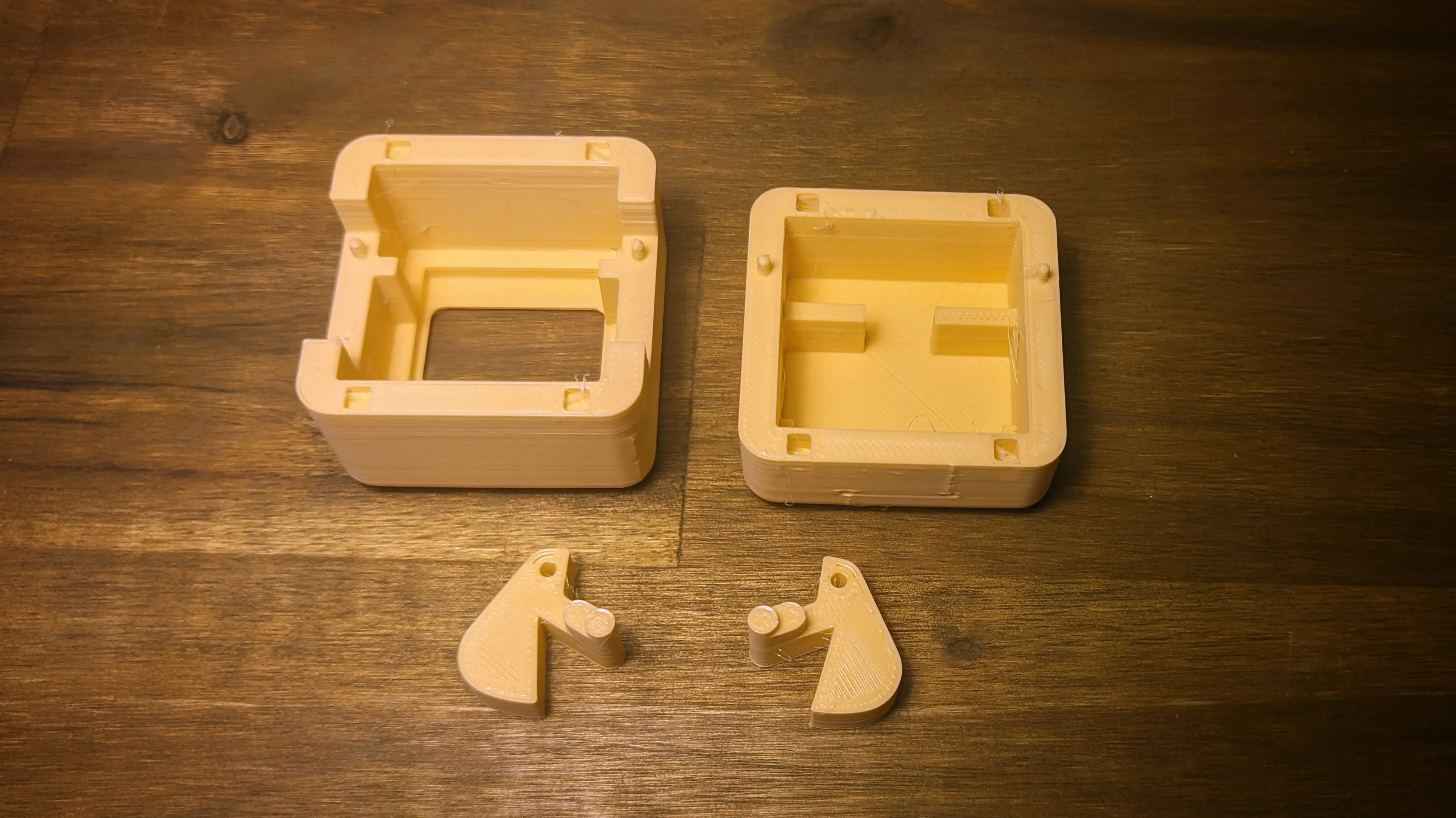 3D-printed case parts placed on desk. All of them are facing down with their flat side.